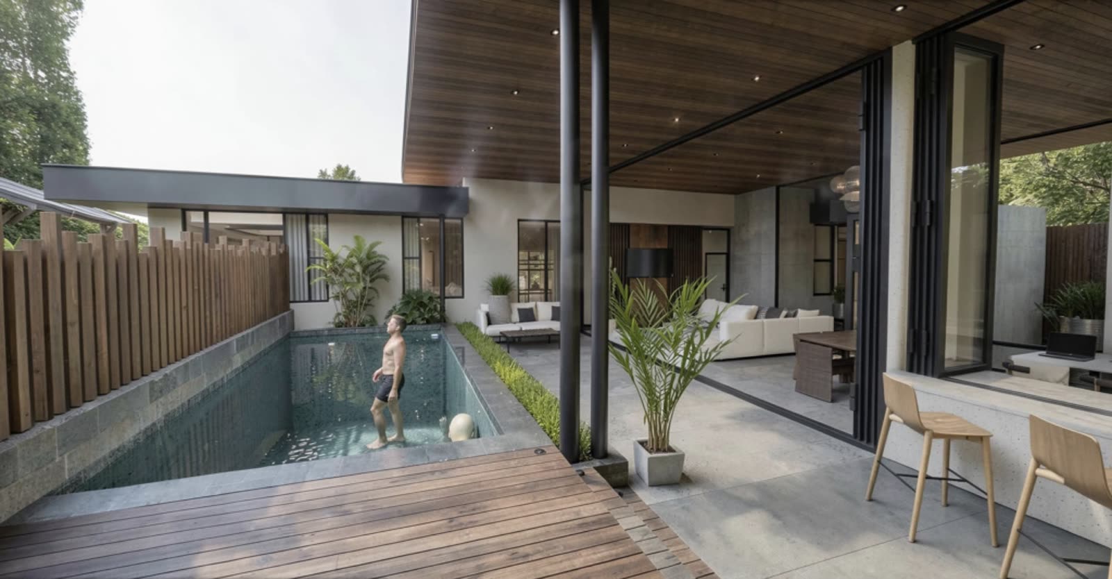 Lap pool with wood deck beside the covered living terrace